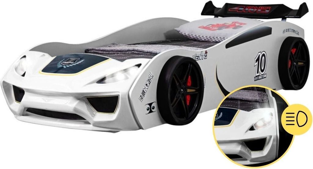 A white race car-shaped children's bed with a spoiler, displayed on a white background. A close-up inset shows the headlights.