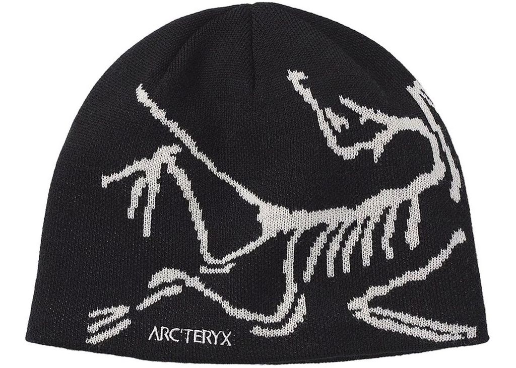A black beanie with a white skeleton graphic and the Arc'teryx logo.