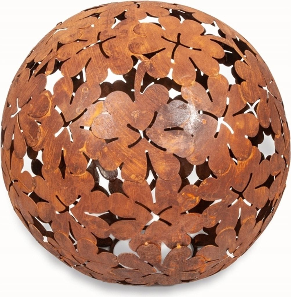 A rusty metal sphere decorated with cut-out leaf shapes, presented against a white background.