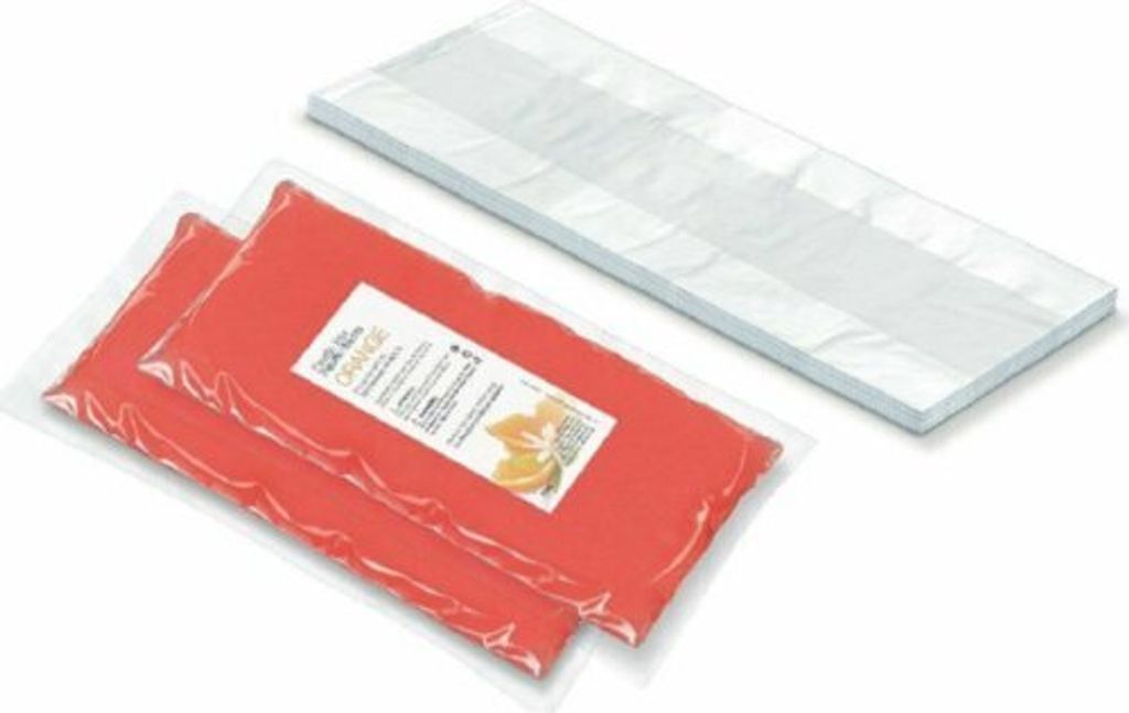 Two orange paraffin wax packs and a white paraffin bath accessory are shown on a white background.