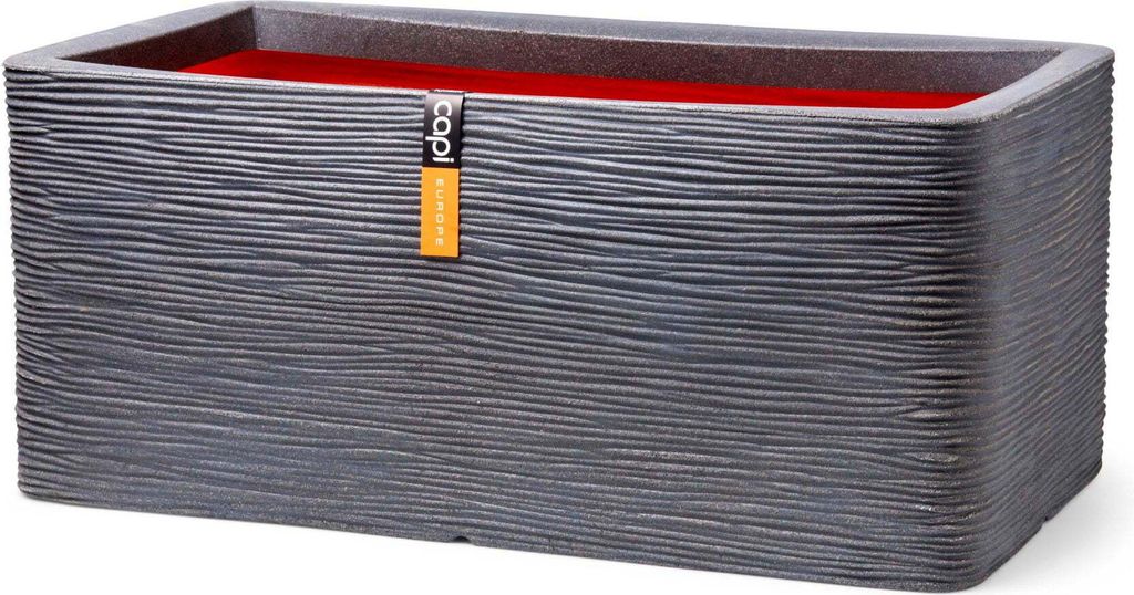 A rectangular planter with a textured dark gray exterior and a red interior, featuring a small orange tag with a logo and text.
