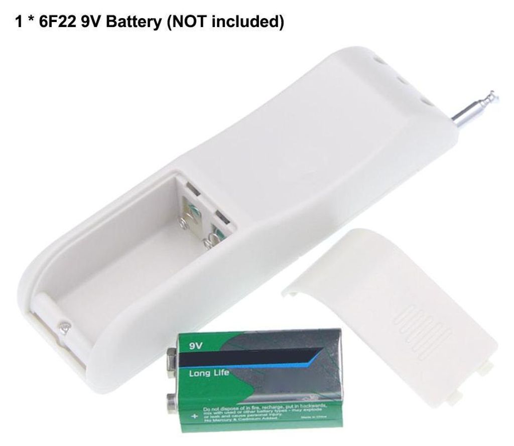 A white remote control with its battery compartment open, showing a 9V battery and the battery cover removed.