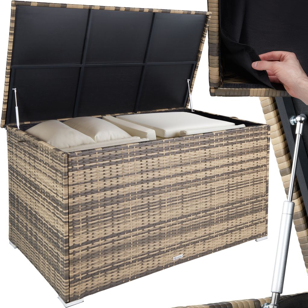 An open storage box filled with cushions, showing its interior and gas struts.