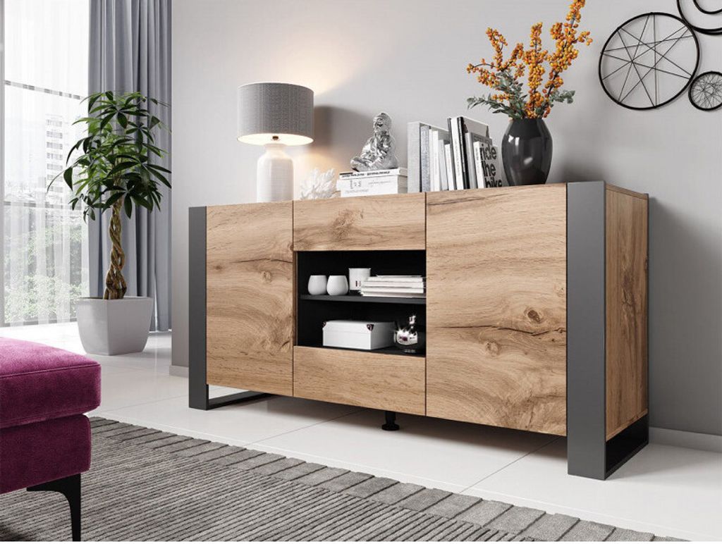 A modern sideboard in a living room setting, with a plant and lamp.