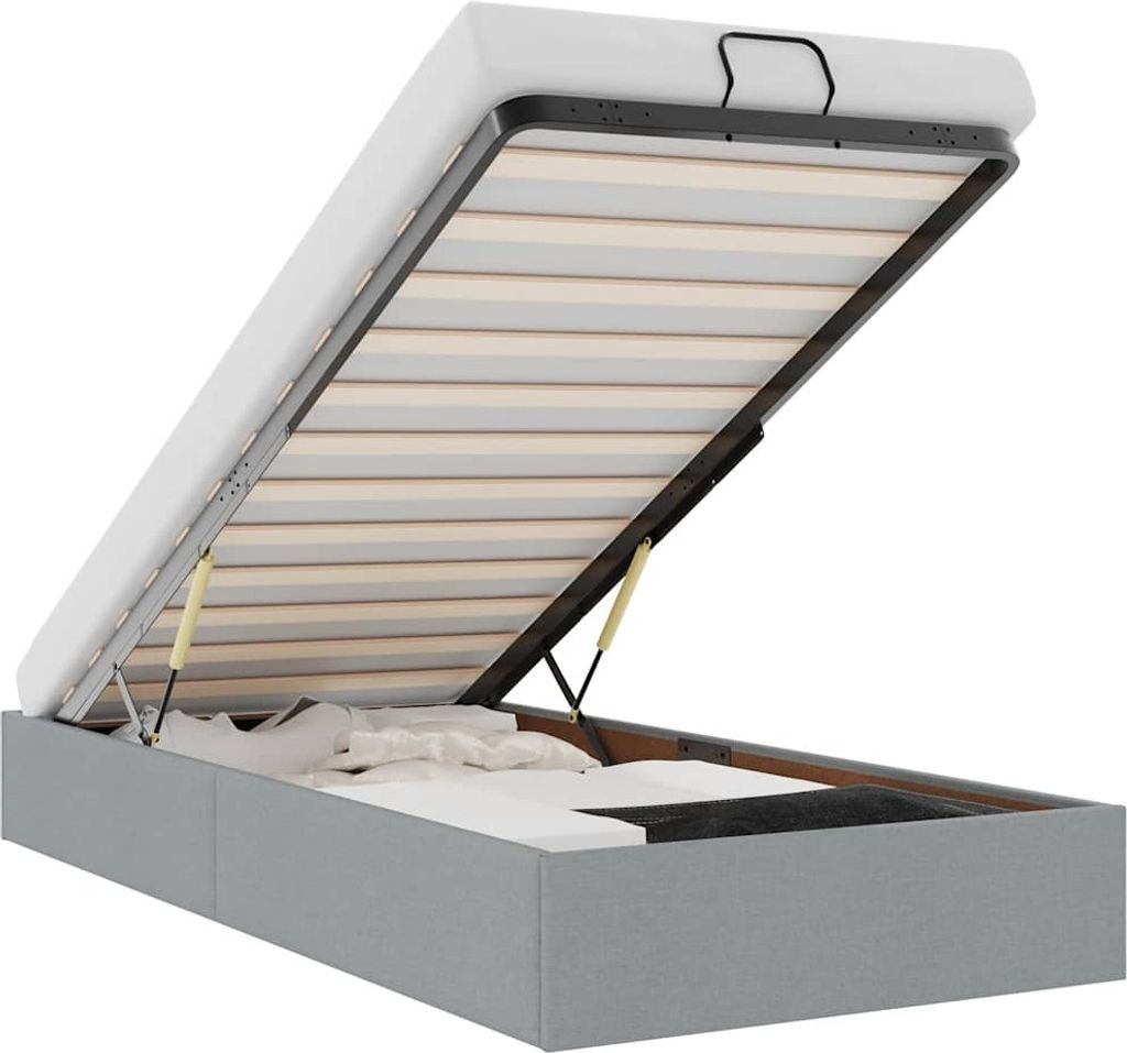 An open ottoman bed frame with a mattress base, showing the storage compartment underneath.