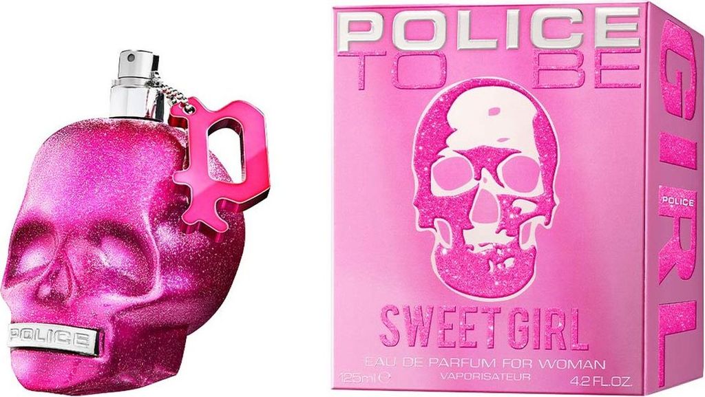 A pink glittery skull-shaped perfume bottle and its matching box are displayed against a white background.