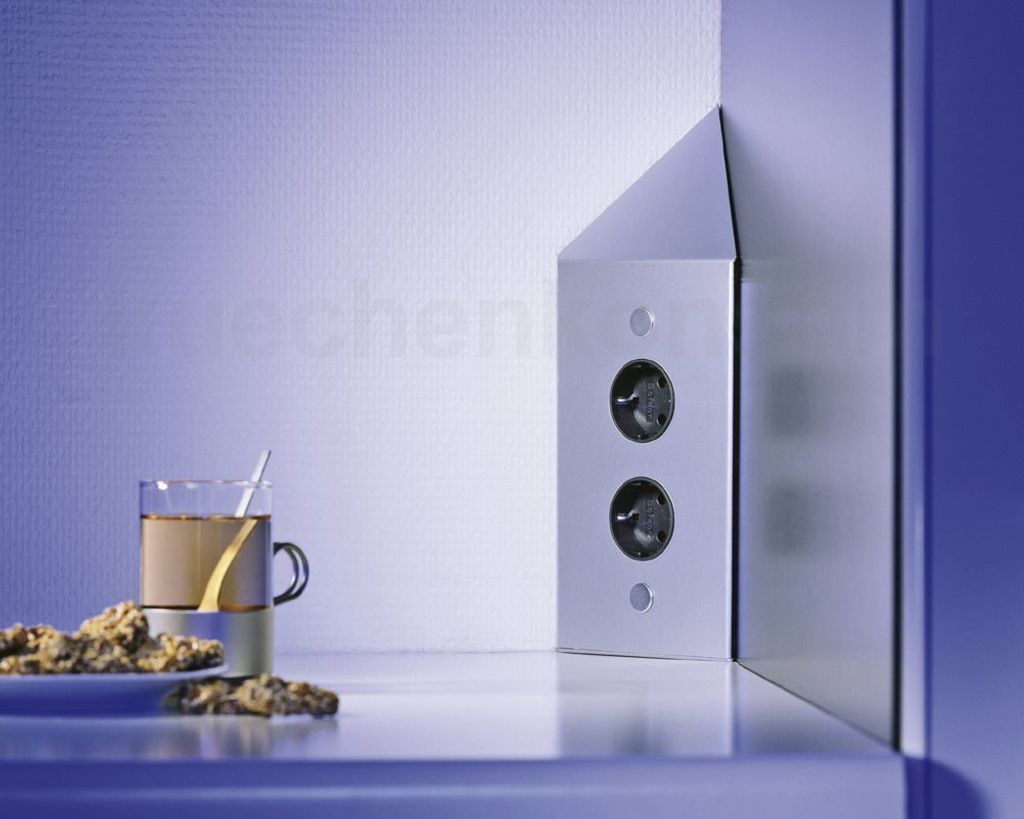 A corner outlet with a cup of coffee and cookies on a reflective surface.