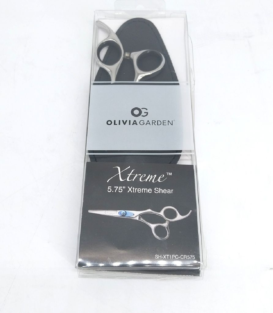 A pair of Olivia Garden Xtreme shears is displayed in its clear plastic packaging.