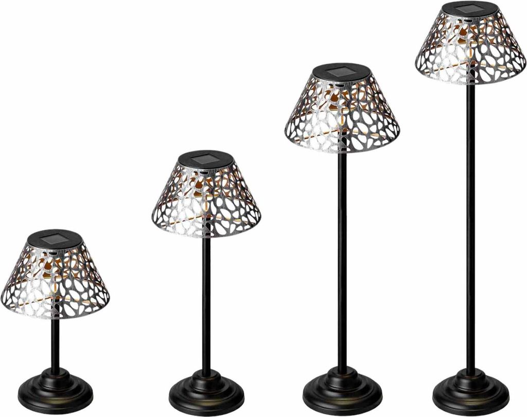 Four solar-powered garden lights of varying heights are displayed against a white background.