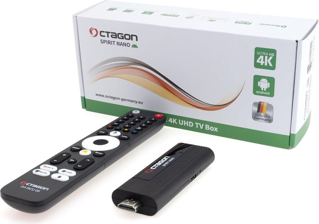 A product shot of a TV box and its accessories, including a remote control and a USB stick, with the product packaging in the background.