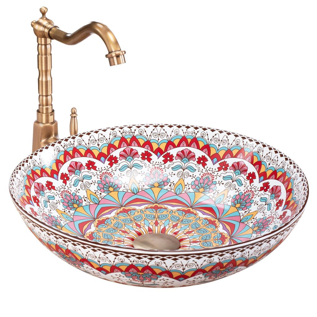 A decorative ceramic sink with a brass faucet.
