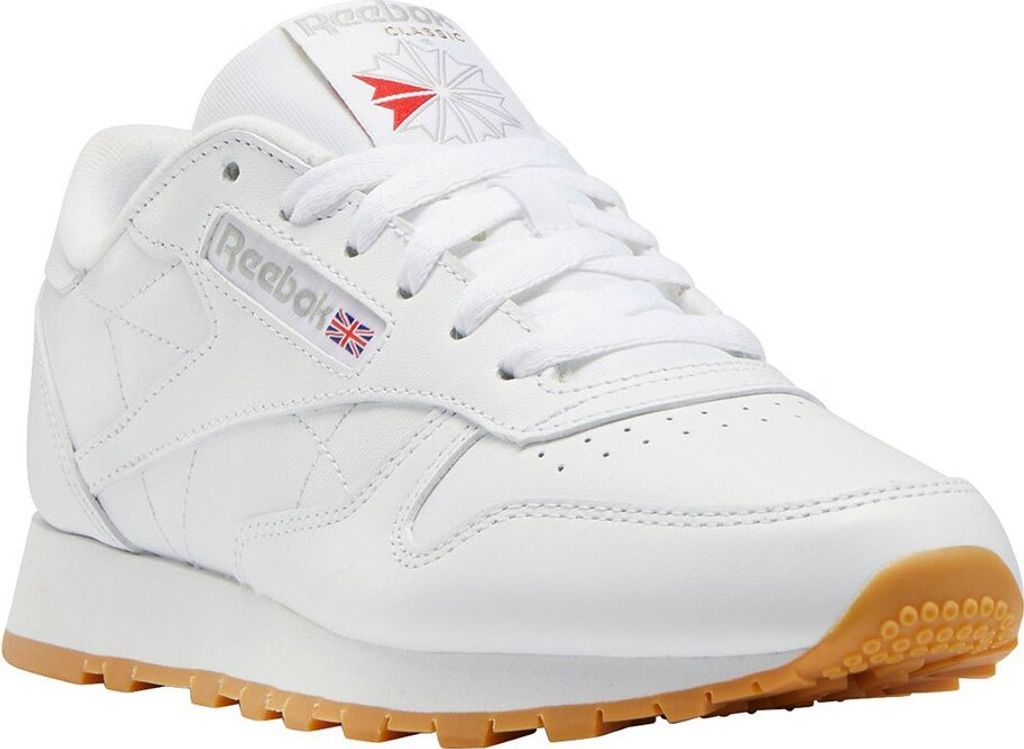 A white Reebok Classic leather sneaker with a gum sole, shown from a side angle.