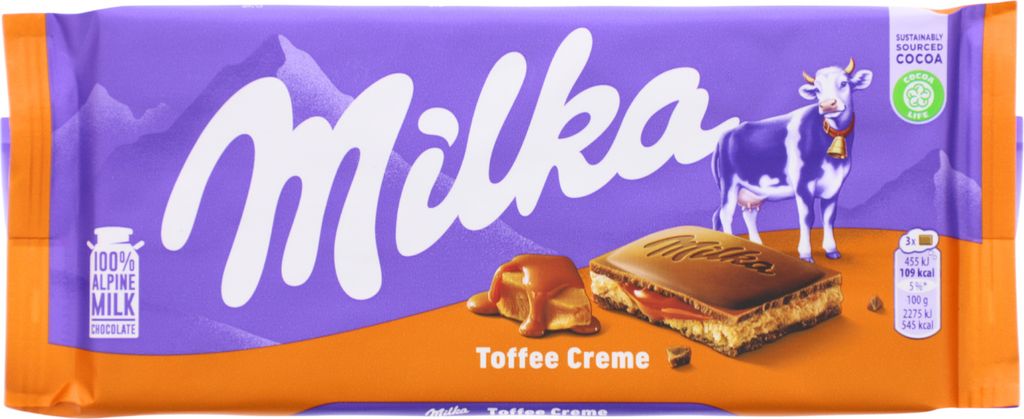 A Milka Toffee Creme chocolate bar wrapper with a depiction of the chocolate bar and a cow.