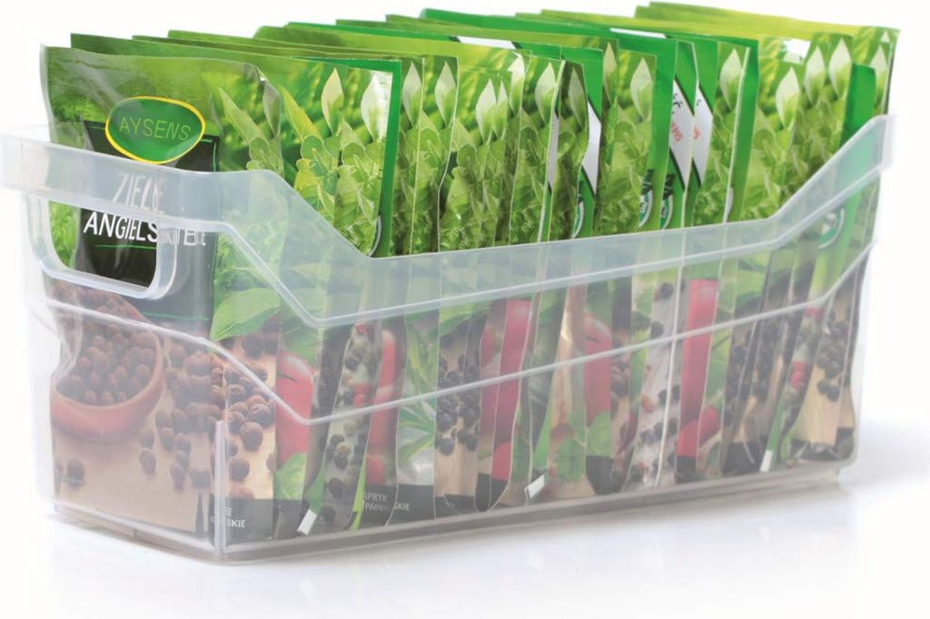 A clear plastic storage container filled with packets of seeds.