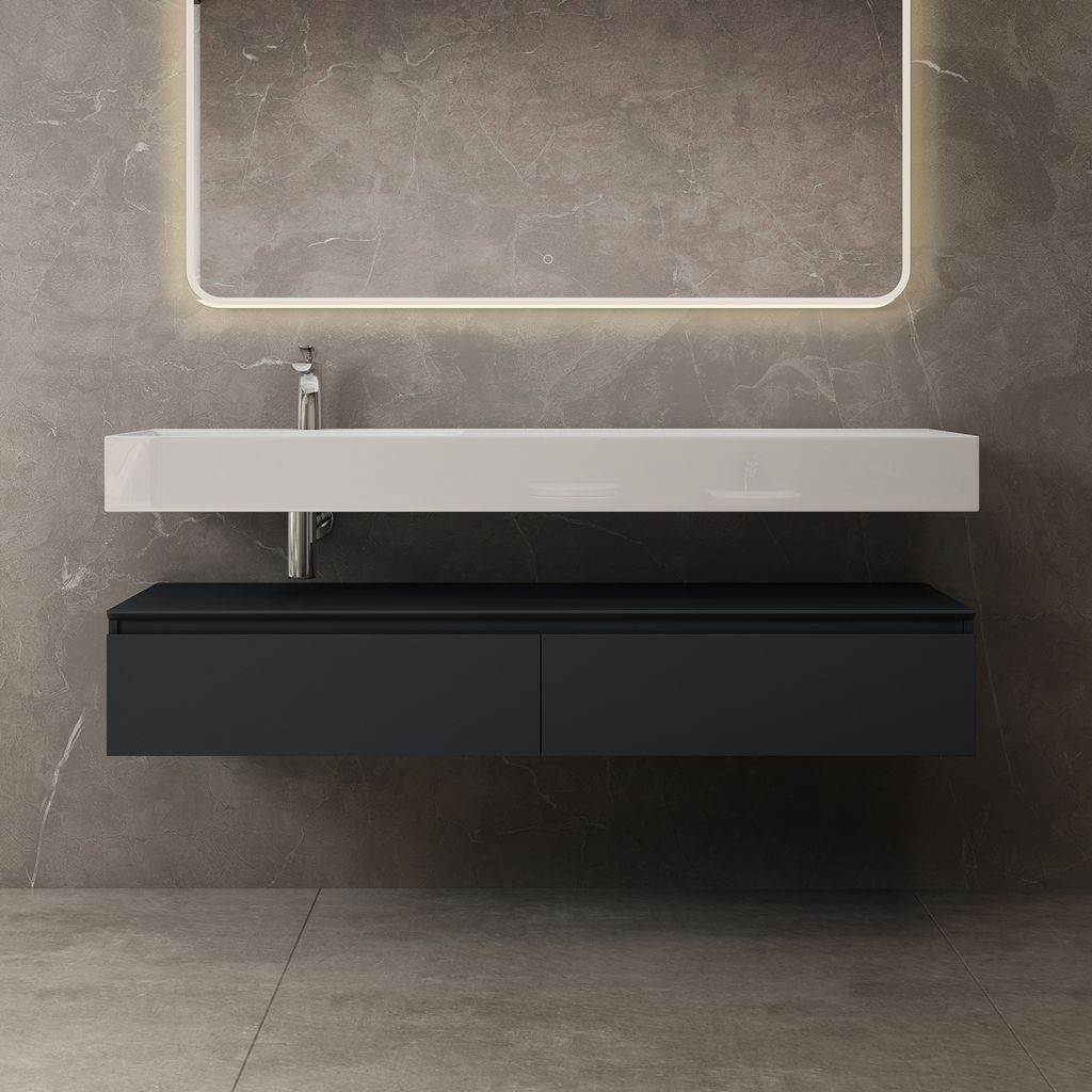 A modern bathroom vanity with a white sink and anthracite drawers against a gray marble wall.