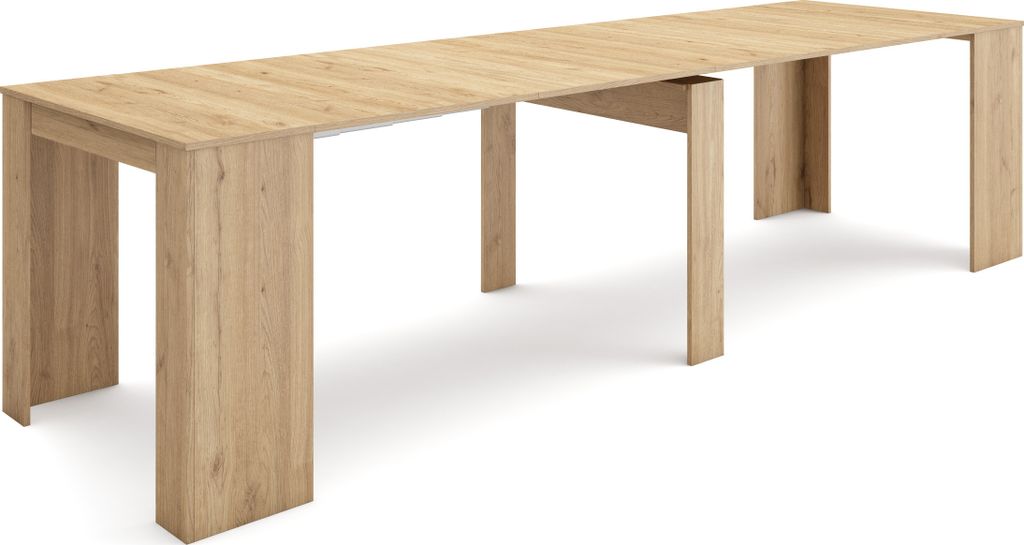A long, light wood dining table with thick, U-shaped legs.