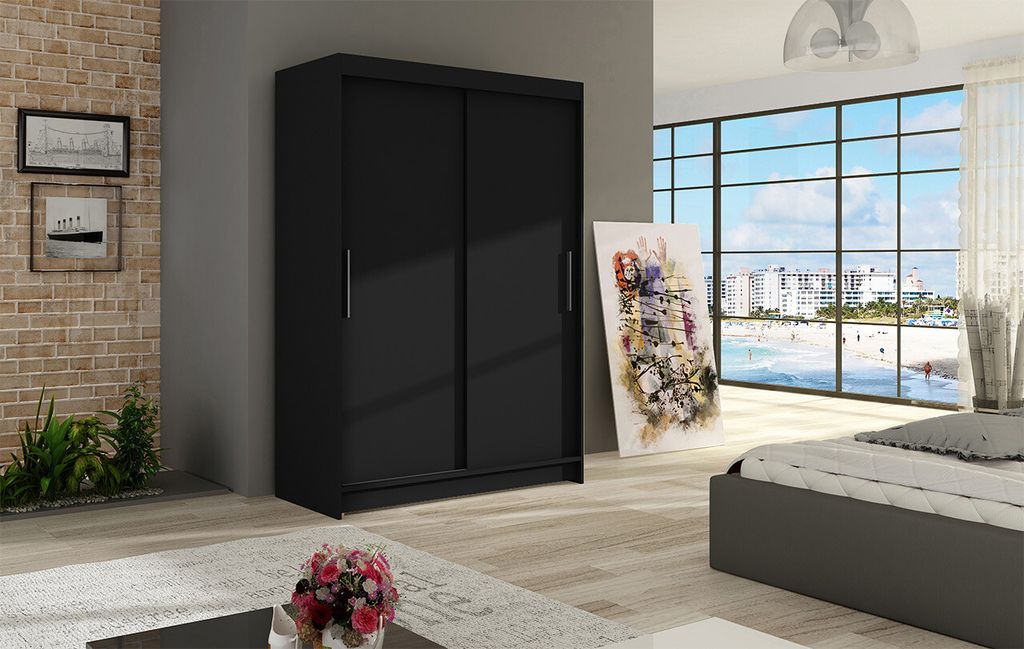 A bedroom scene with a black wardrobe, bed, and artwork.