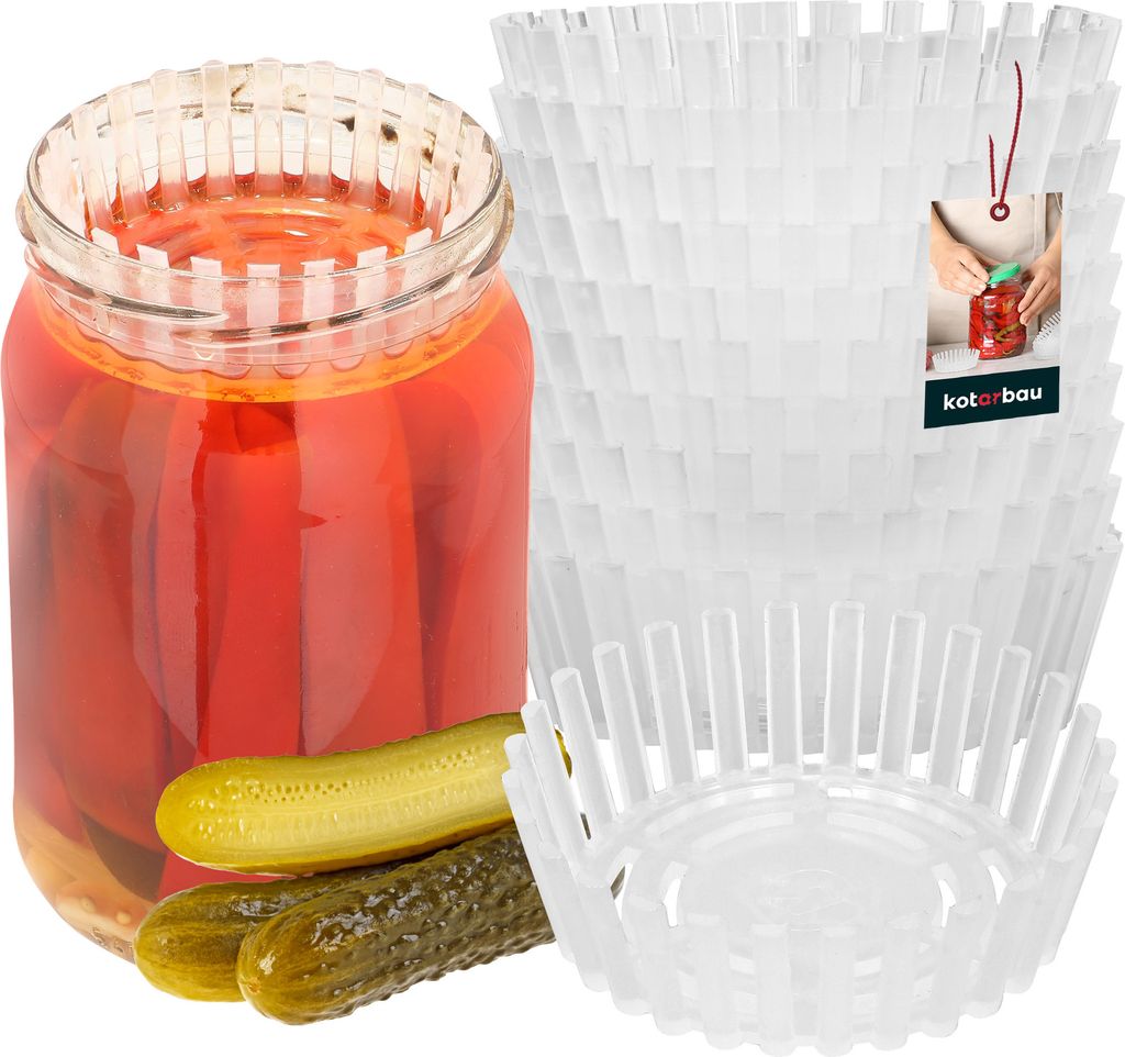 A jar of pickled red peppers and pickles next to a stack of white fermentation weights.