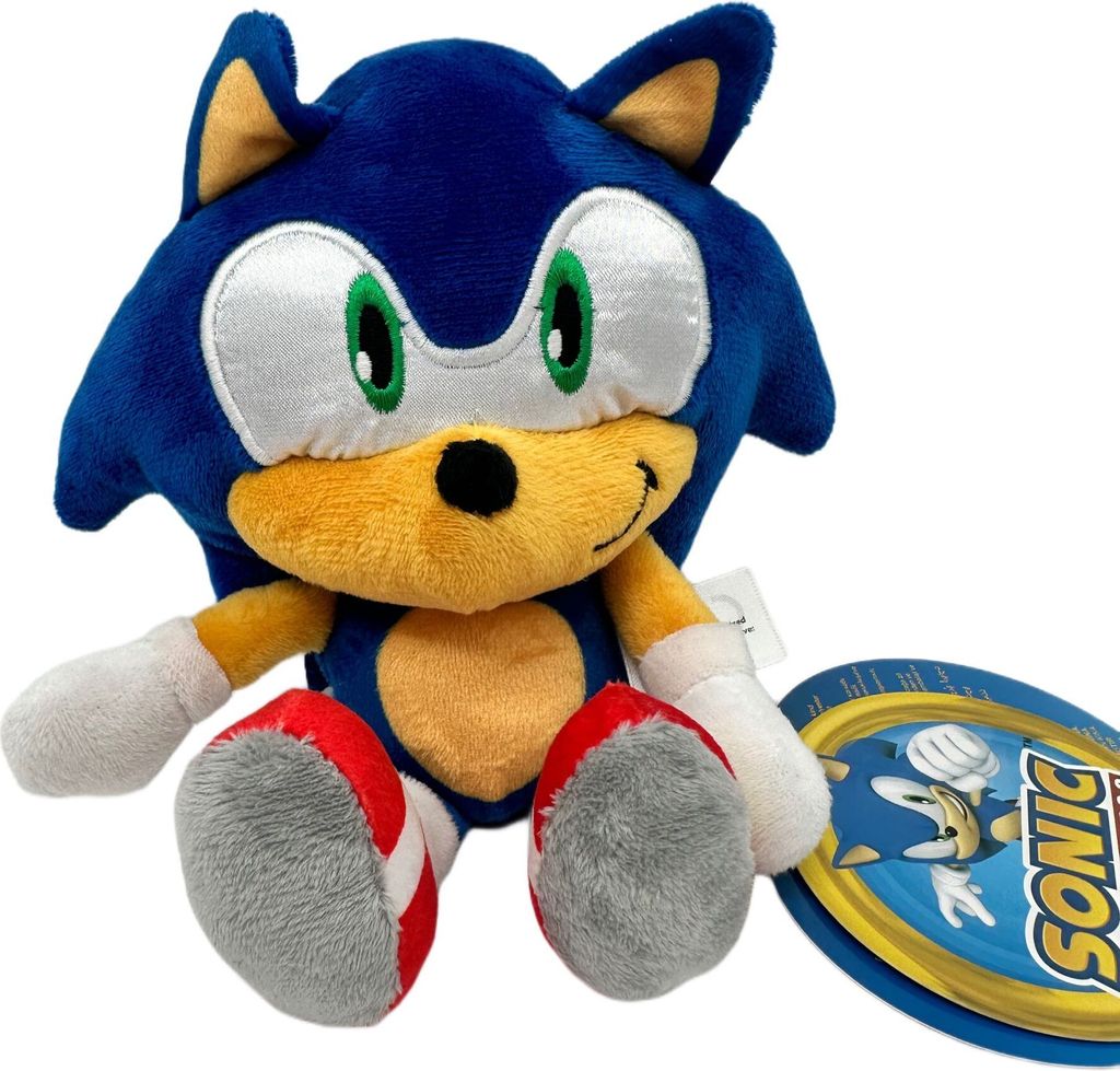 A plush toy of Sonic the Hedgehog is shown sitting down, with a product tag next to it.