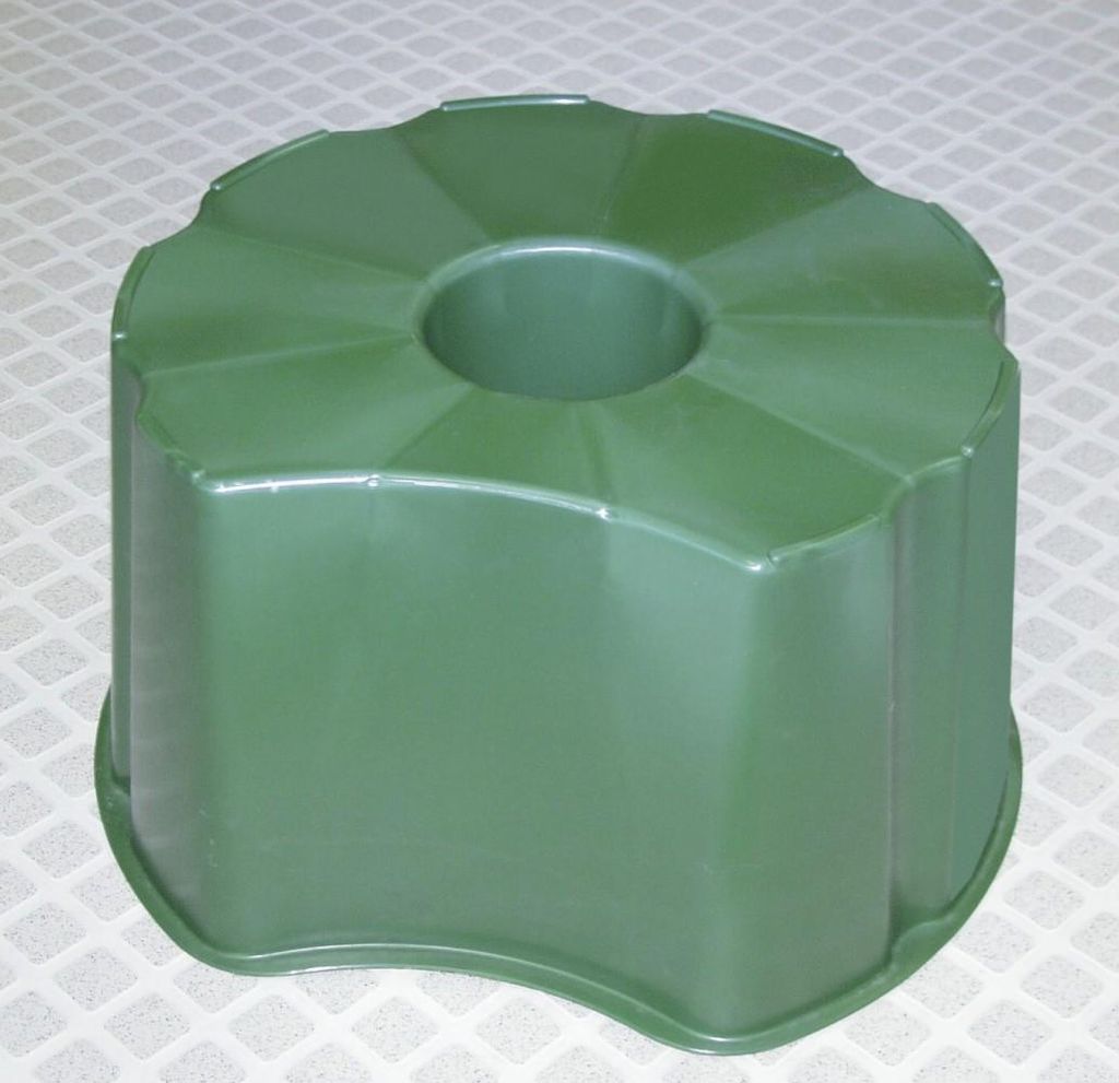 A green plastic stand for a rain barrel.