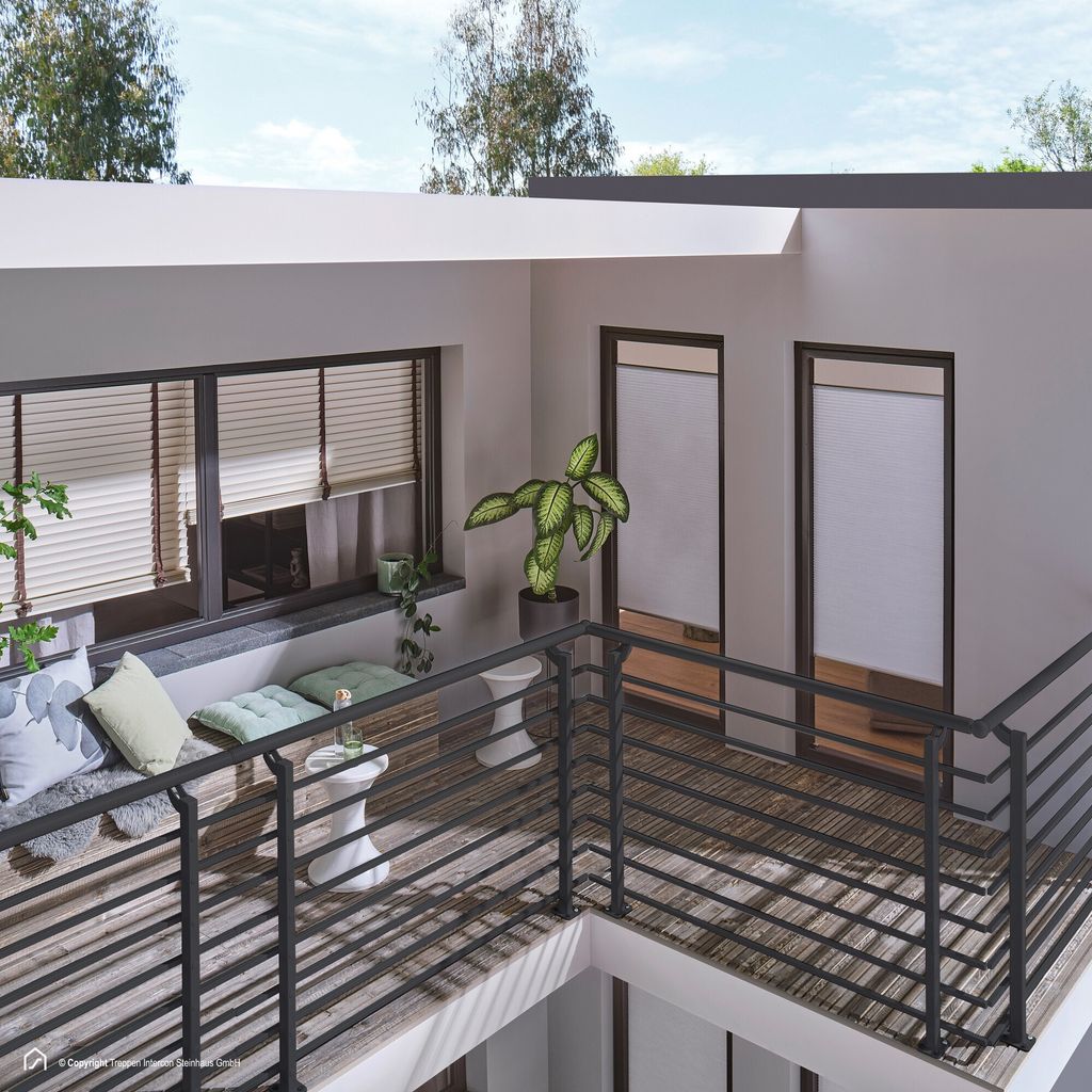 A balcony with a railing system and seating area.