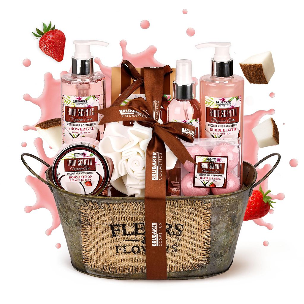 A gift basket filled with bath and body products, decorated with strawberries and splashes of pink liquid.