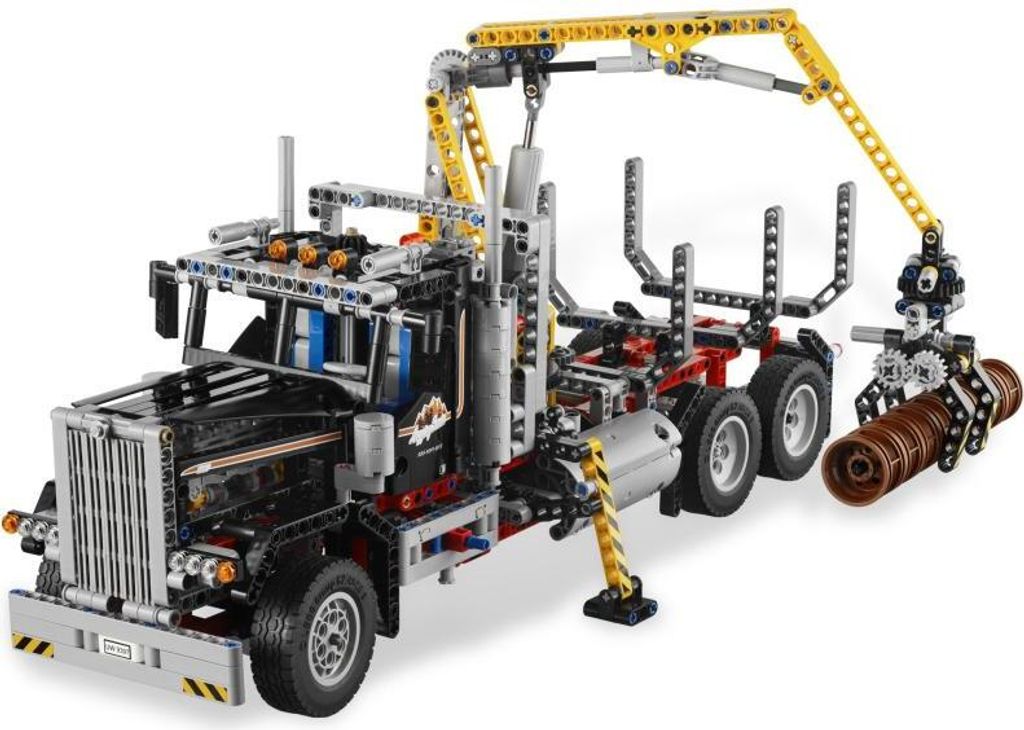 A Lego Technic logging truck with a crane and logs.