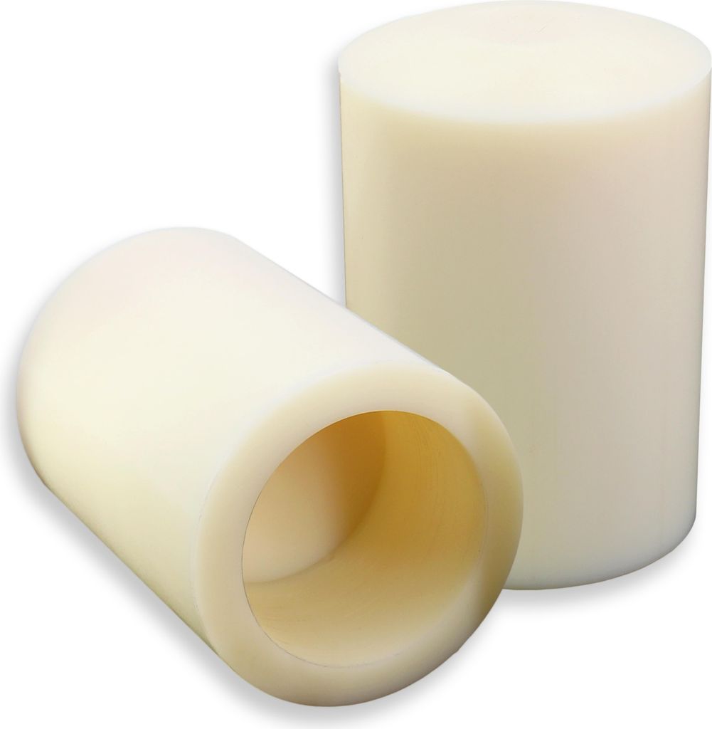 Two cylindrical objects, likely plastic or polymer, are shown against a white background. One is upright, and the other is lying on its side, revealing a hollow interior.