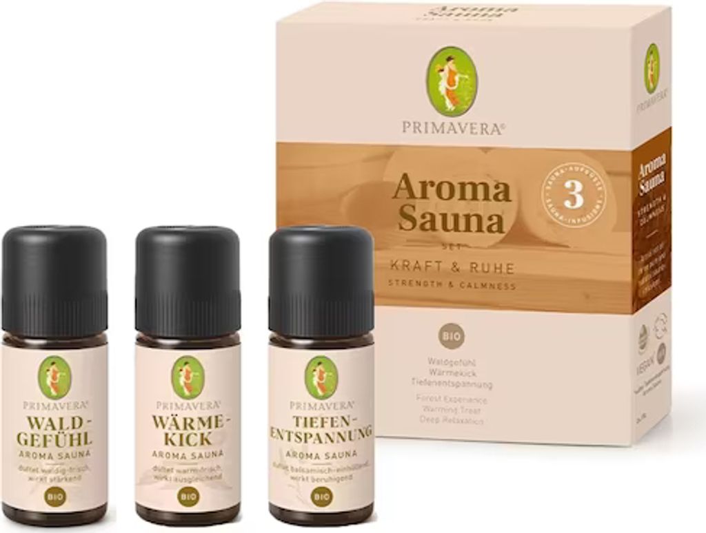 Three small bottles of essential oil are arranged in front of a product box.