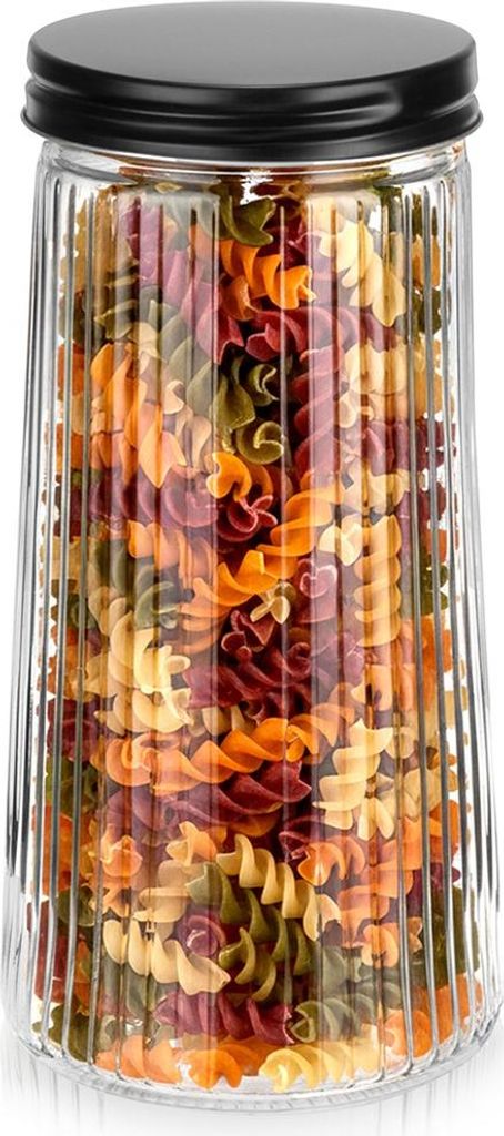 A clear, well-lit studio shot of a glass storage jar filled with colorful fusilli pasta, placed on a white background.