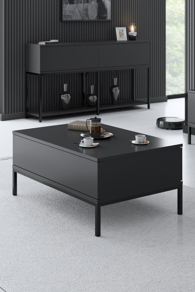 A modern living room scene featuring a black coffee table with two cups and a teapot, and a black sideboard in the background.