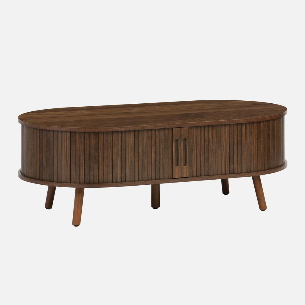 A wooden coffee table with ribbed detailing and two doors, presented against a plain background.
