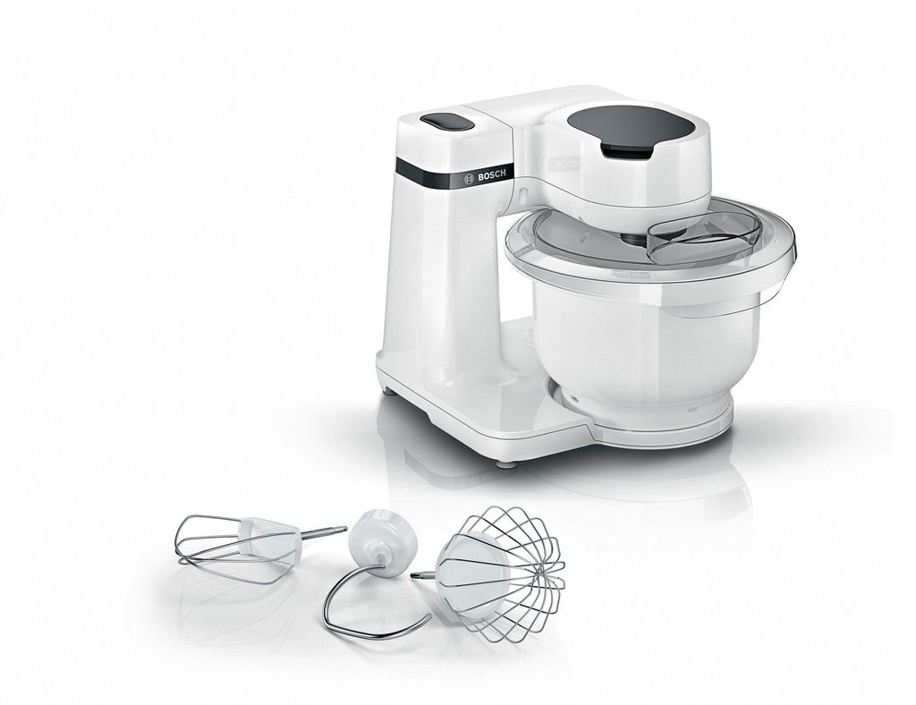 A white Bosch stand mixer with its attachments displayed in front of it, on a white background.