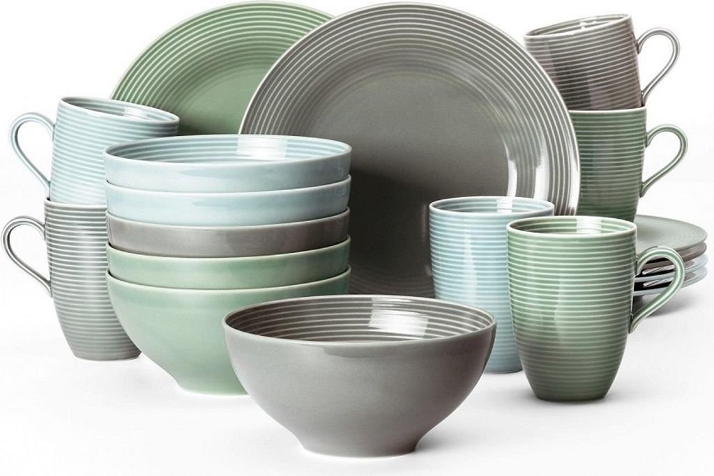 A collection of ceramic dishes and mugs in various shades of gray, green, and blue, arranged on a white background.
