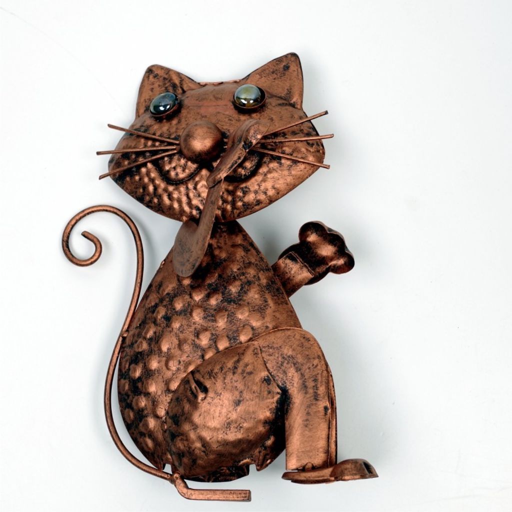 A copper-look metal cat figurine is shown against a white background.
