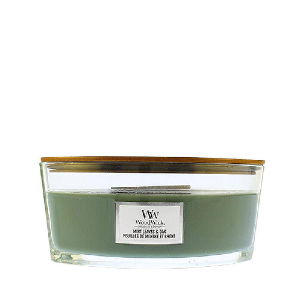 A WoodWick candle with a wooden lid and a label.
