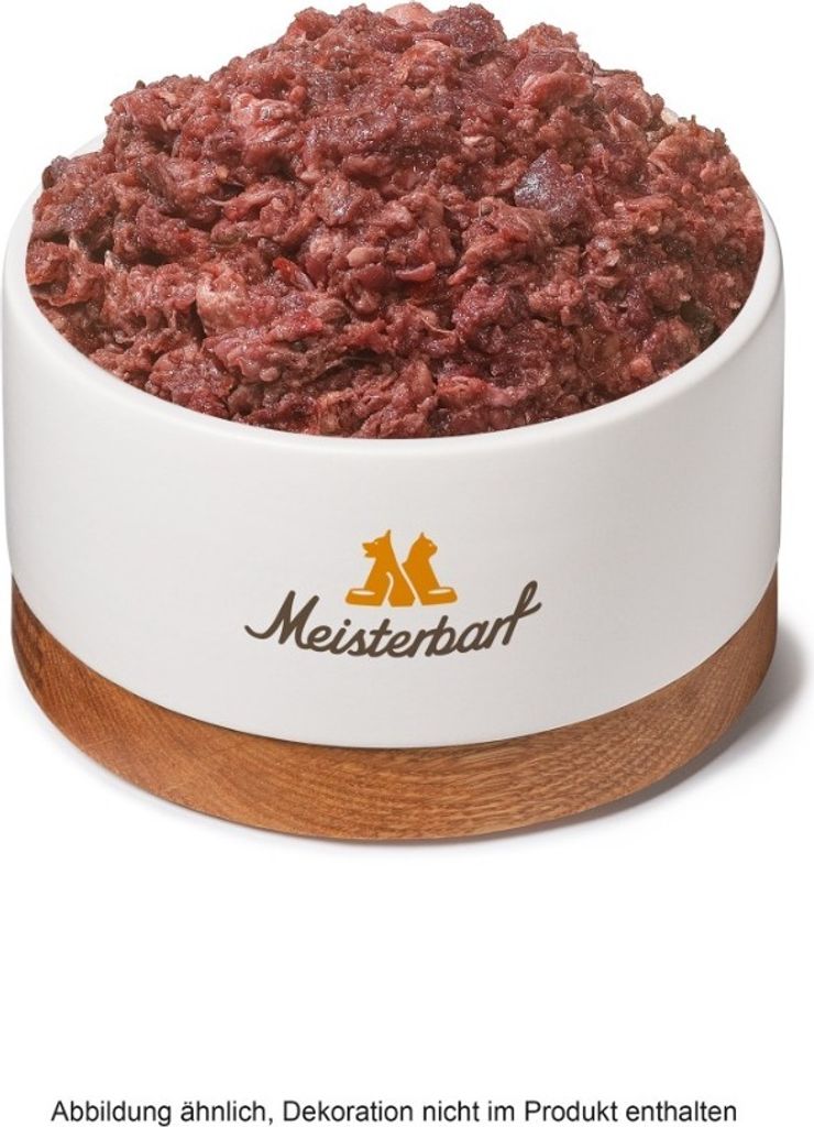A bowl of raw dog food with a wooden base and a logo on the side.