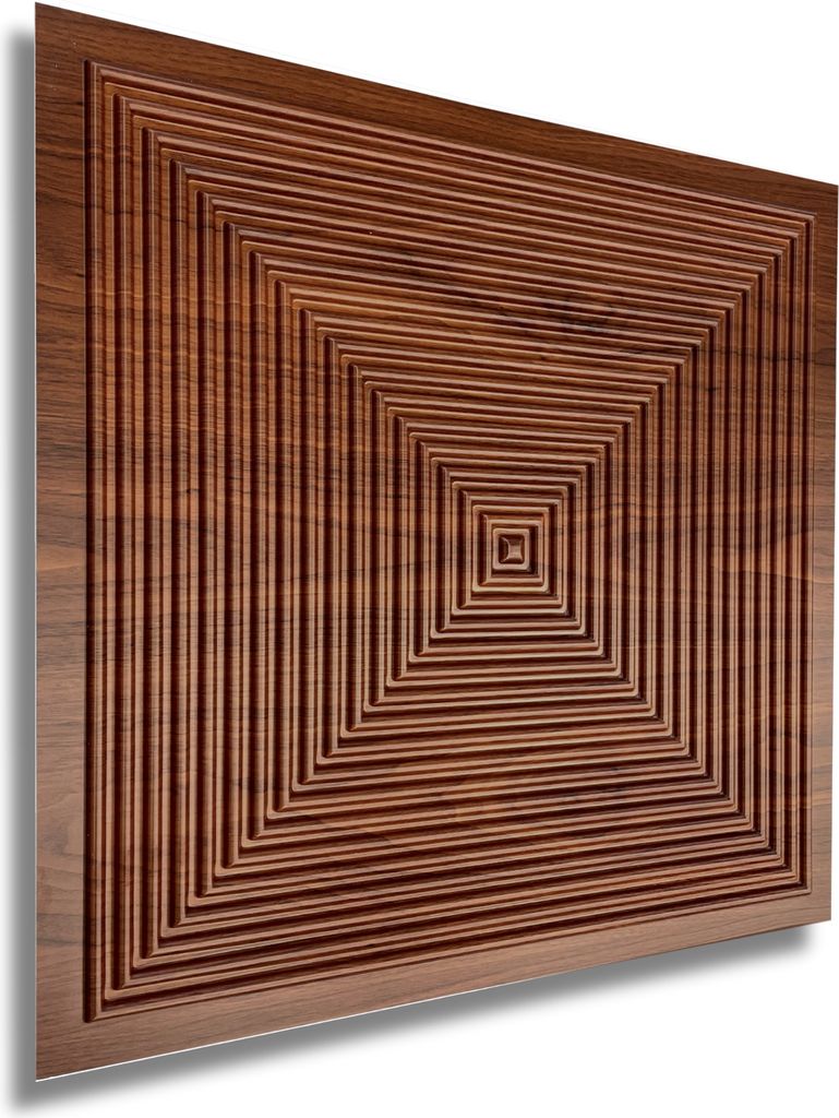 A close-up, angled view of a wooden wall panel with a geometric, concentric square pattern.