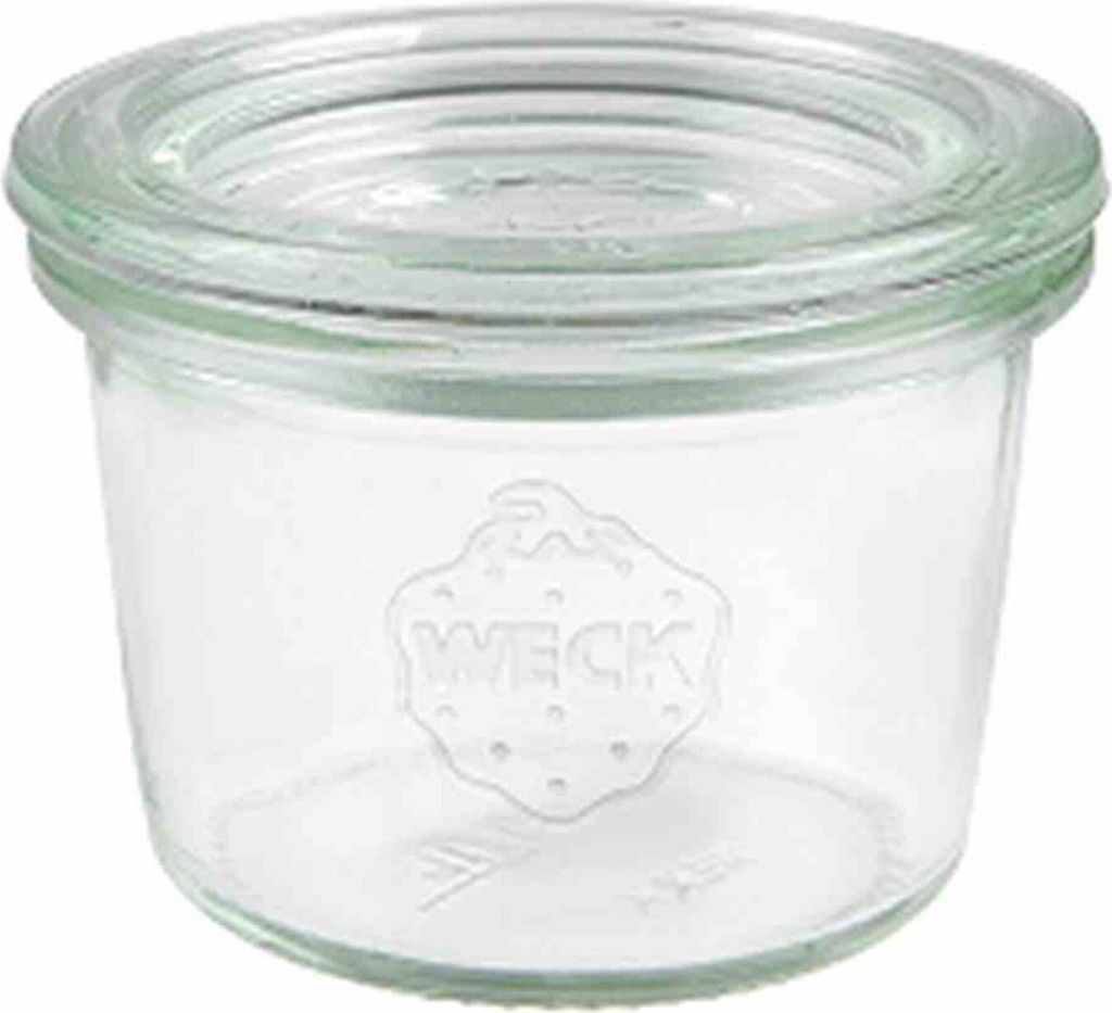 A clear glass jar with the brand name embossed on it.