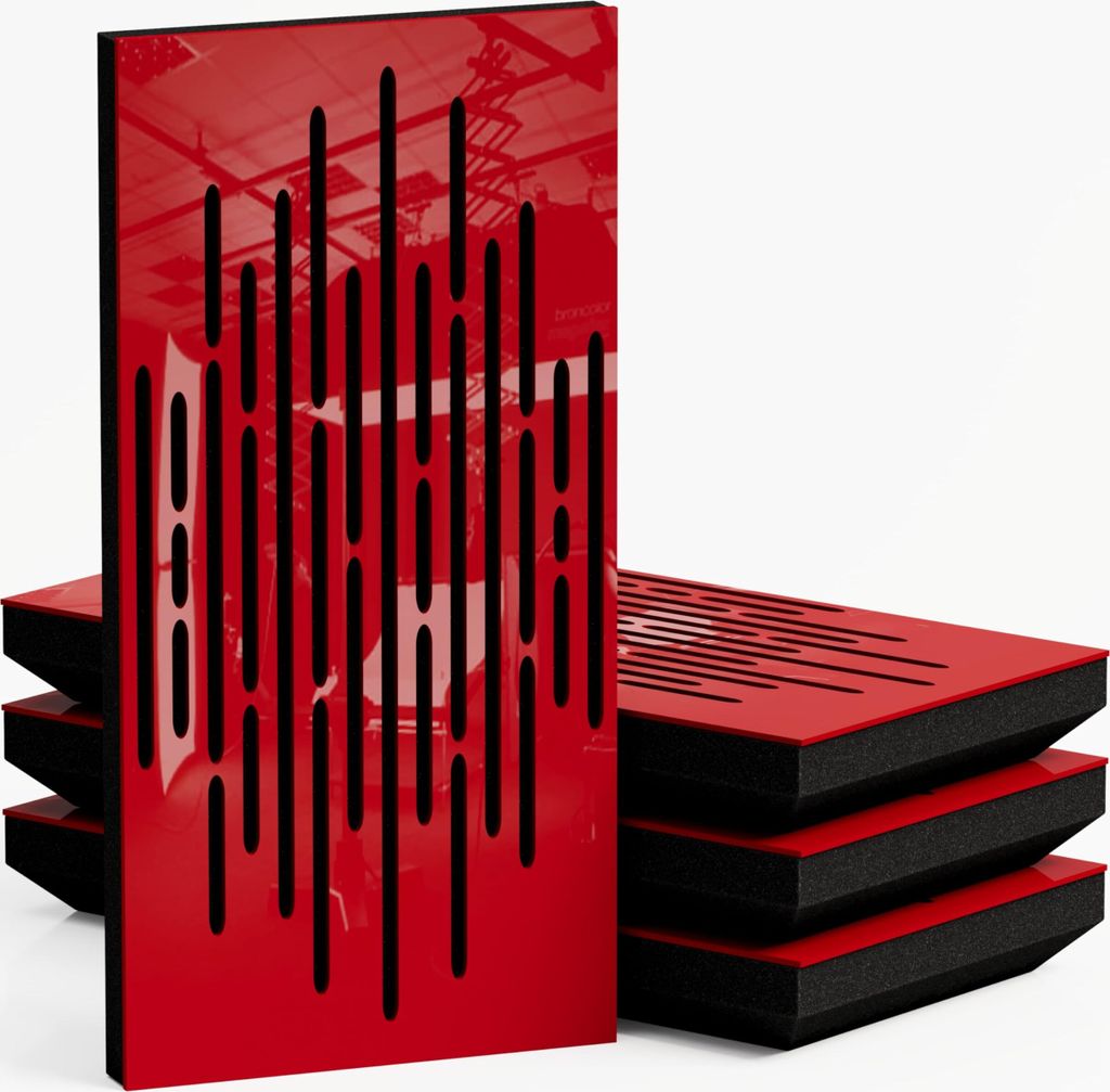 A stack of red acoustic panels with black cutouts, with one panel standing upright in the foreground.