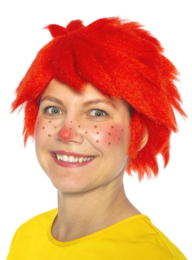 A woman wearing a red wig and face paint, smiling at the camera.