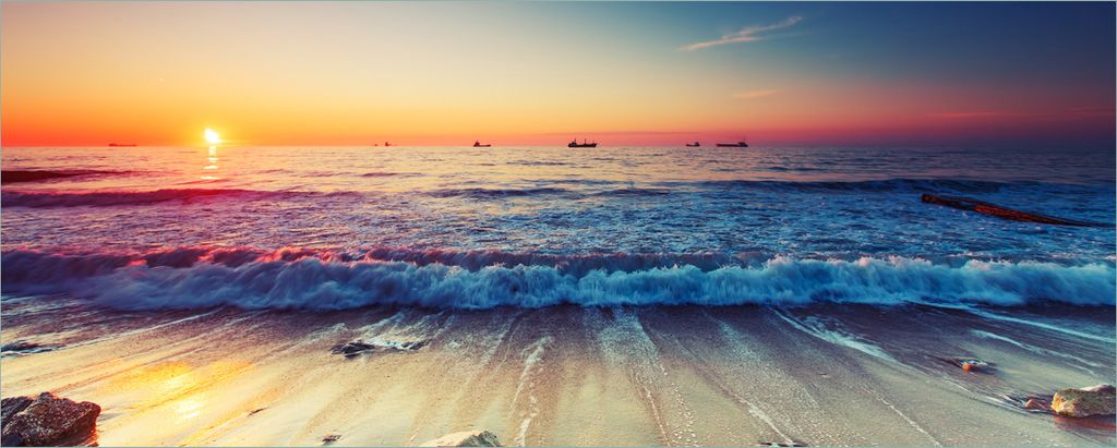 Wallario Poster - Sonnenuntergang am Meer mit Wellen am Strand, Kunstdruck Größe: 80 x 200 cm