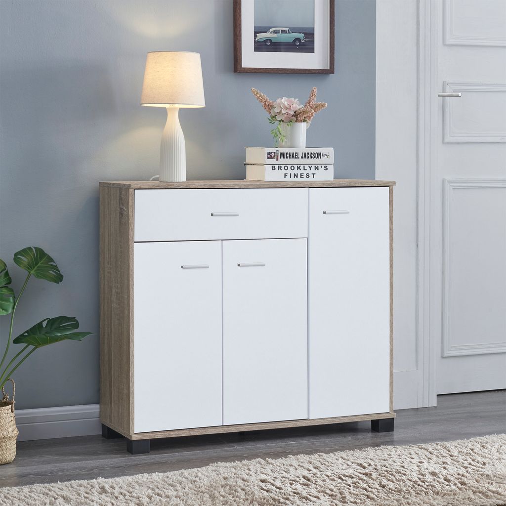 A modern entryway cabinet with a lamp and decorative items.