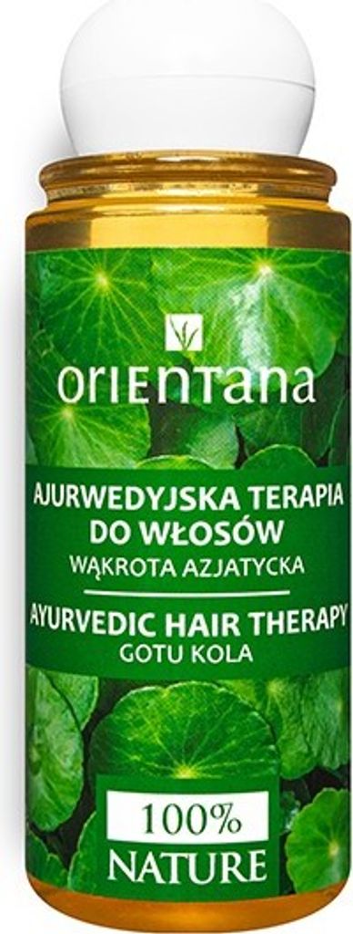 A product shot of a bottle of hair therapy with green leafy background.
