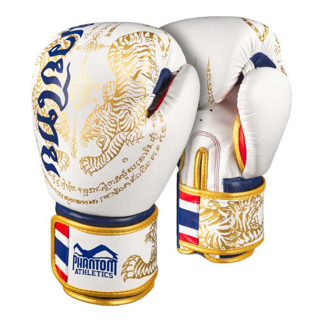 A pair of white and gold Muay Thai boxing gloves with intricate designs.