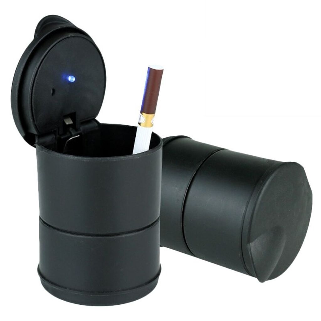 A black car ashtray with a cigarette in it, and another ashtray in the background.