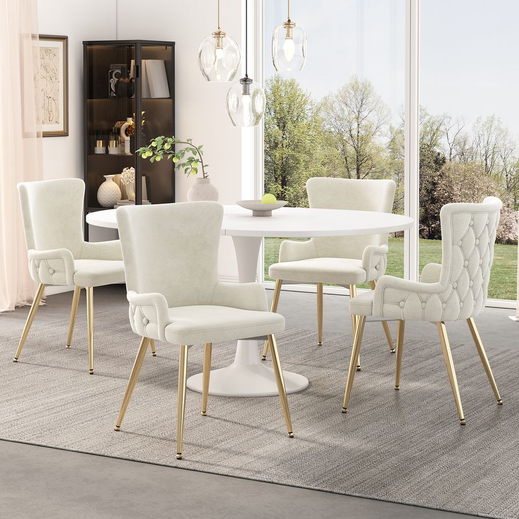 A dining set with four chairs and a table in a well-lit room with a large window overlooking a garden.