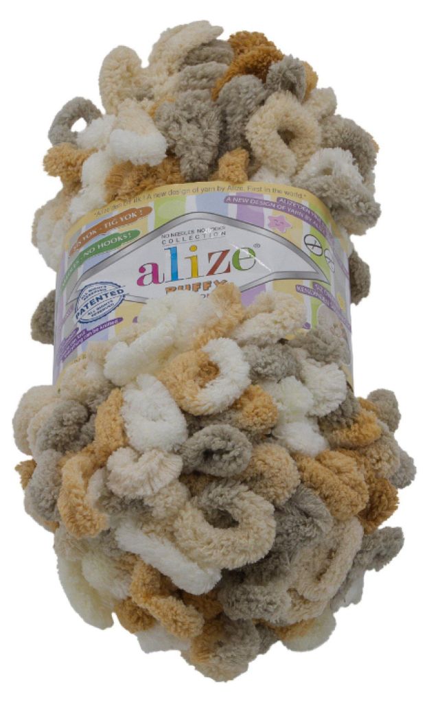 A ball of textured yarn with loops, in various shades of beige, white, and gray.