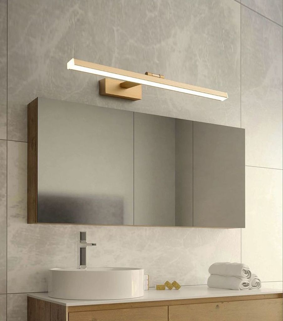 A modern bathroom vanity with a sink, faucet, mirror, and a gold LED light fixture above the mirror.