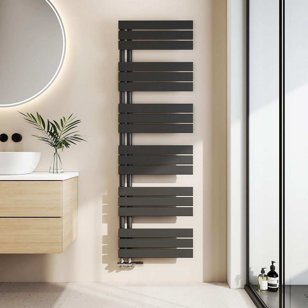 A modern bathroom with a sink, vanity, and a black towel radiator.